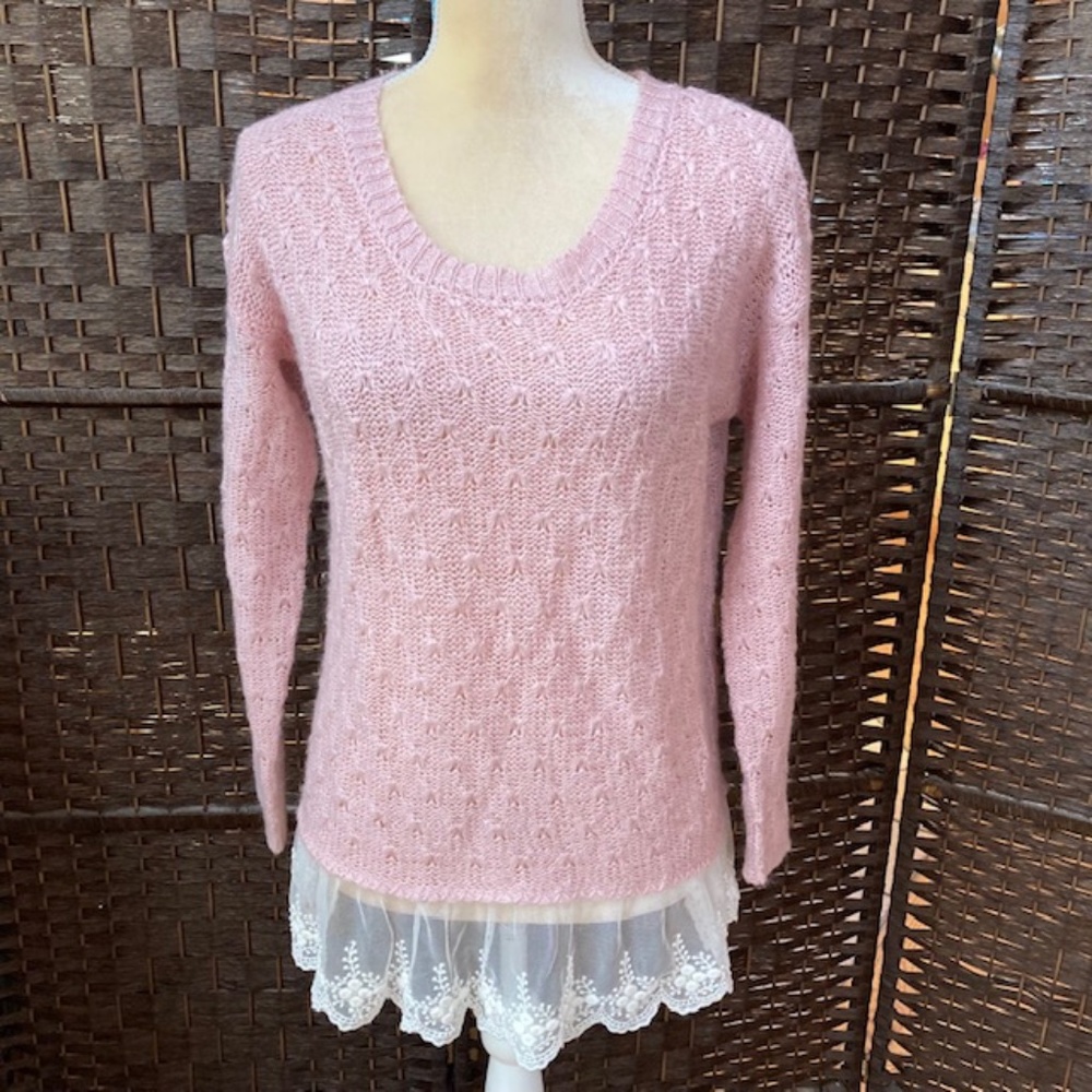 JUST ONE woman’s pink sweater
